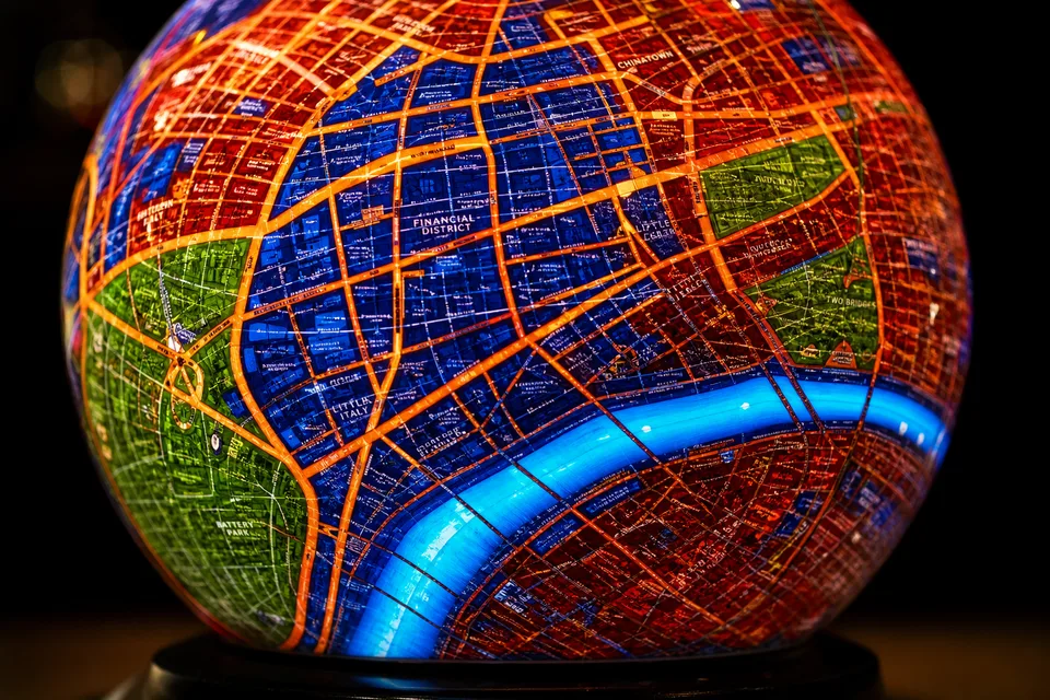 Close-up of crimson and indigo artistic city map on glass sphere